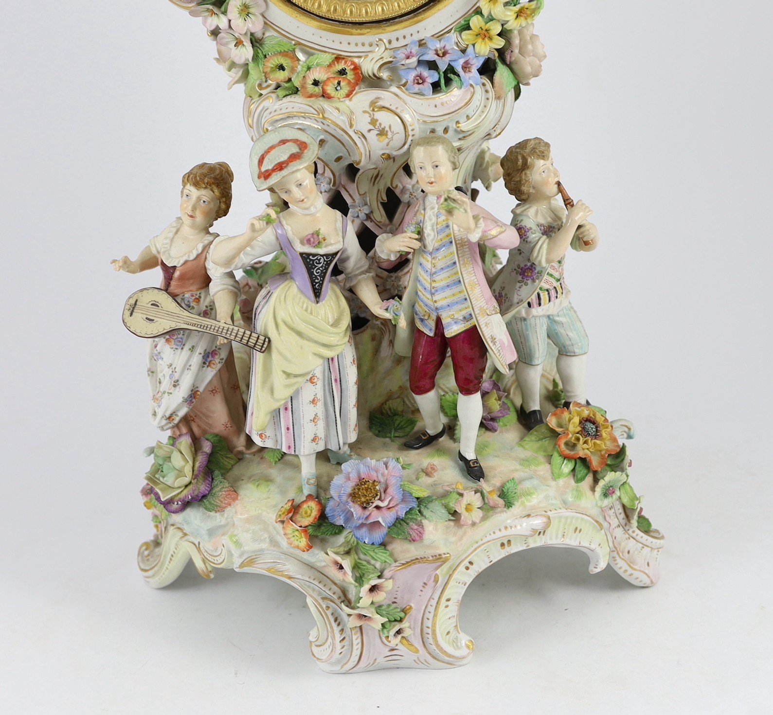 An impressive German porcelain floral encrusted figural mantel clock, late 19th century, Total height 65 cm